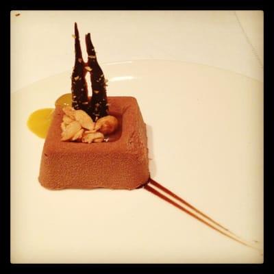 Chocolate mousse drizzled with mango coulis. Yummy