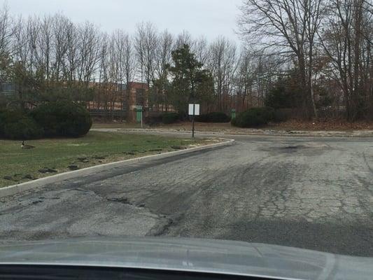 The parking lot riddled with pot holes