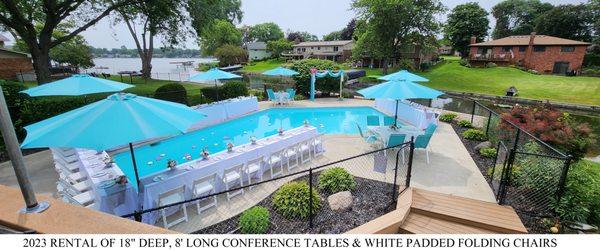 Conference tables (18" deep, 8' long) with white, padded seated folding chairs