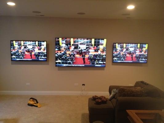 80" center TV with two  50" TV's on the sides. All mounted with swing arm mounts.