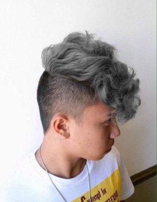 Fresh faded pompadour with a smokey, slate grey color to bring out his curls!