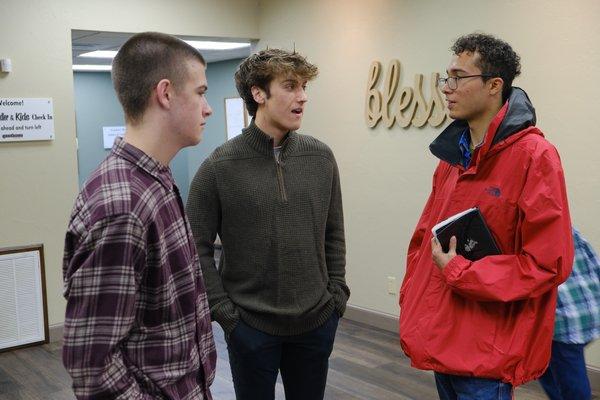 GNC's young adults conversing in the lobby