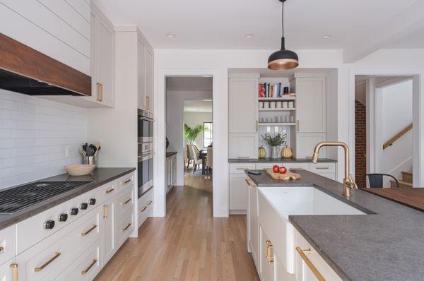 Spacious and sleek, this kitchen boasts a wood-accented island and built-in appliances, setting the stage for culinary creativity.