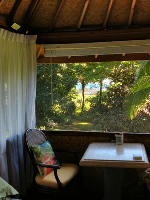 Hawaii ocean view from oceanfront bali hut vacation rental. Tropical gardens. Discount in April.