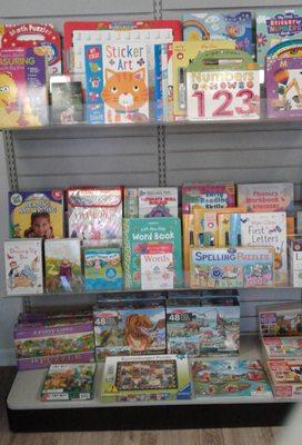 A small section of the Preschool area with puzzles along the bottom shelf.