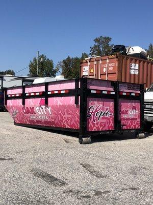 We wrapped one of our containers for breast cancer awareness month. We will be donating $10 per every load dumped in the month of October.