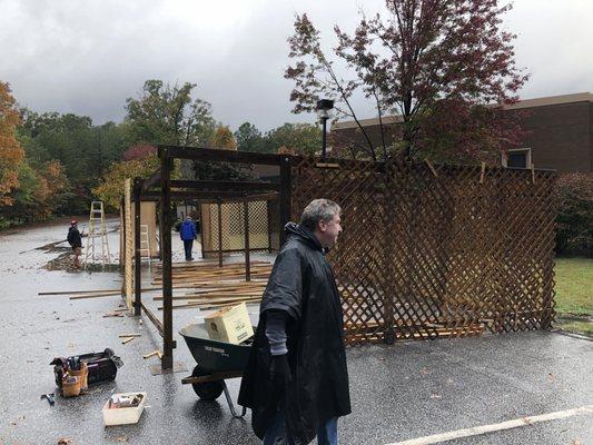 Volunteers disassembling the sukkah