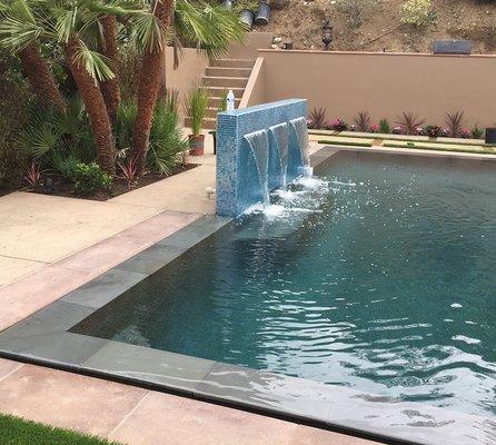 Here we did hardscape and added a beautiful waterfall to the pool end.