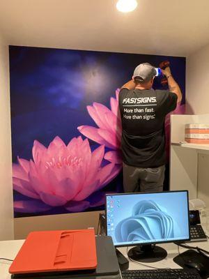 Transforming walls into works of art!  FASTSIGNS expertly installs an eye-catching wall wrap in an office. Elevate your space! #FASTSIGNS