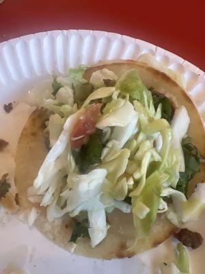 Taco de asada  contains cilantro, onion, cabbage,tomatoe lime salsa