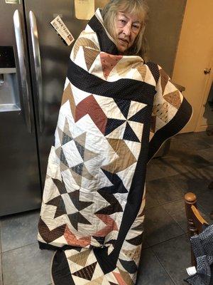 My grandma, modeling the quilt I made with the fabrics I got from GRS!