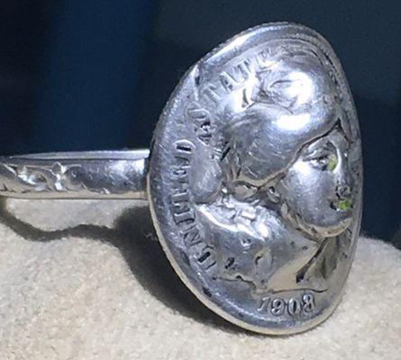 1908 Liberty coin's reeded edge, wheated hair and crown detail completely buffed off, gouges added, ring spray painted.