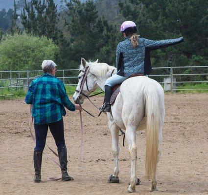 Student working on her balance on a school horse