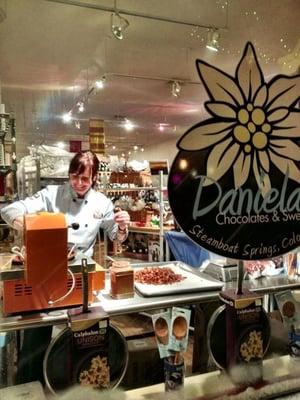 Daniela is busy making chocolates and candied nuts.