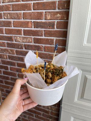 Popcorn chicken in front of the garage door