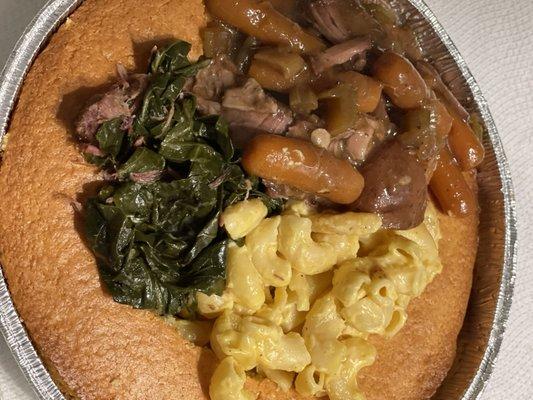 Cornbread pan. Topped with Greens with Smoked Neck Bones, Mac and Cheese, with Roast and Veggies.