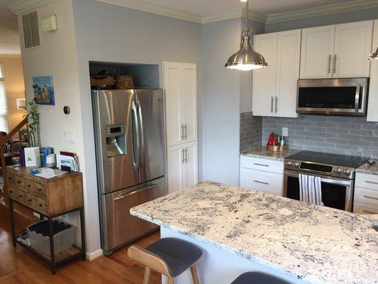 Whole kitchen view; the pantry is to the right of the fridge and has custom doors to match the rest of our cabinets.