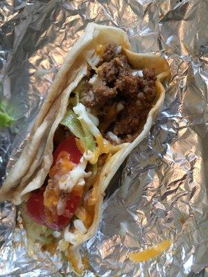 Picadillo on flour with tomato, lettuce , shredded cheese and potato