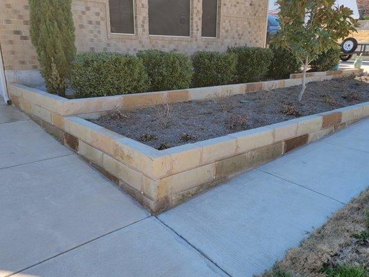 Built up flower beds to make the stone level