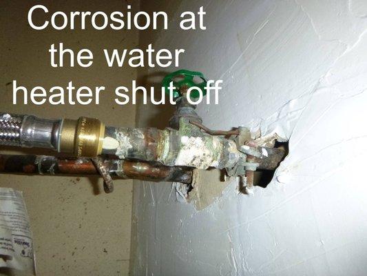 Inspecting: Corrosion at the water heater shut off