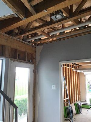 Framing studs and plywood sub floor drying after a water pipe burst.