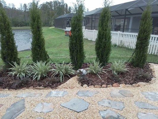 A modern landscape design with stepping stones and River rock.