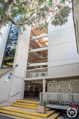 View from east side of the building of the building. Open air building with cover from sun and rain.