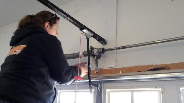 One of our repair technicians getting a start on a garage door torsion spring repair.