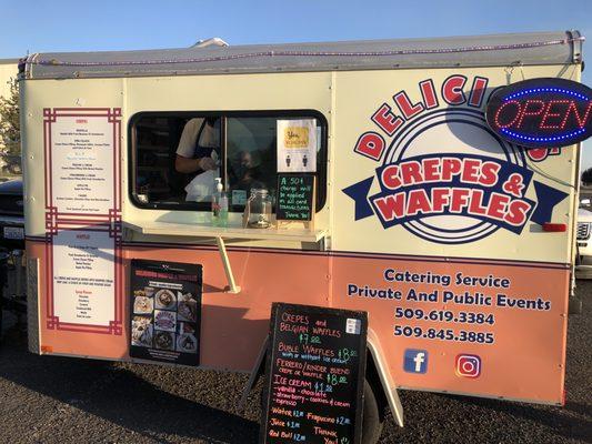 Their trailer with their menu on the left ride of he trailer