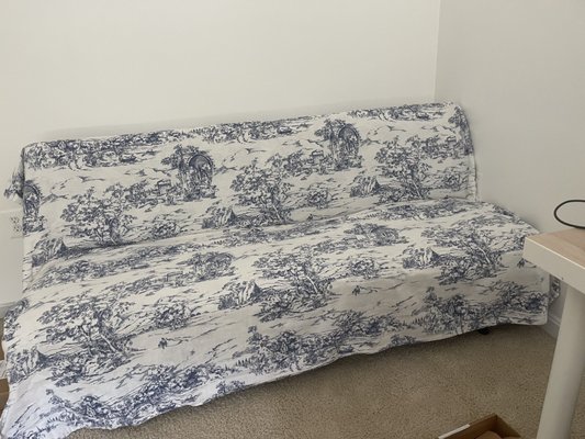 Picked up this queen size duvet cover in a blue toile for $3. It worked great to cover the ugly futon in my husband's home office.