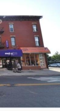 Orange awning for the salon at the corner of Somers Street.