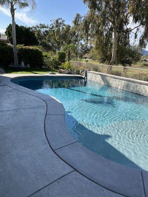 New coping around the pool replacing previous flagstone and new mini pebble tech in a light blue color.