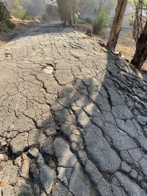 Damaged asphalt driveway, about to get an overlay on top