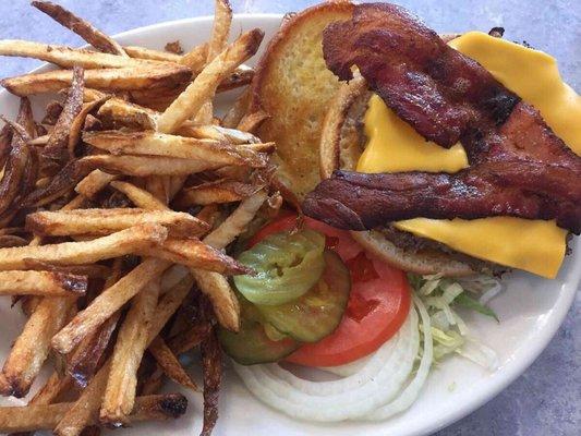 Bacon cheeseburger with French fries. Next to this plate was 4 bottles, each with ketchup, mustard, mayo, and fry sauce, Idaho style.