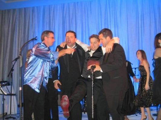 Stu and Savoir Faire cover band on stage with groomsmen