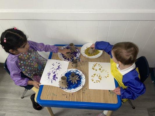 Children creating and exploring with household materials.