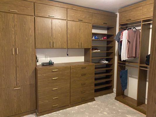 Men love wood tones in their closets. This handsome design features a hutch, adjustable shoes shelves and lots of hidden storage.