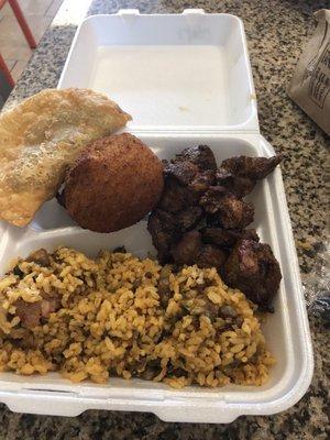 Rice with beans, Pork, beef empanada and potato ball.