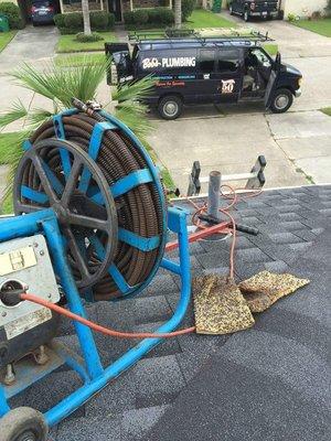 We are on the roof running the sewer machine through the kitchen stack vent to unstop the kitchen sink drain line.