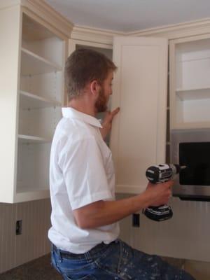 Installing newly painted cabinet doors