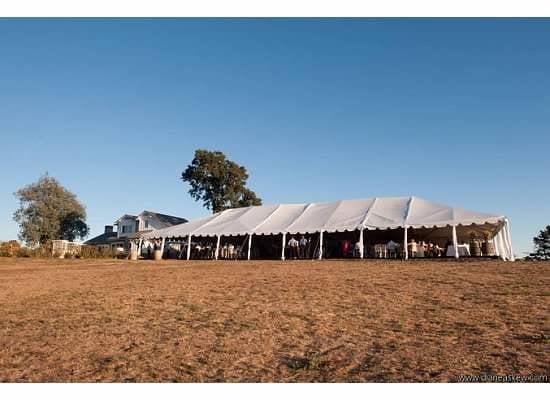 Sonoma Wedding with a huge tent, suflooring, custom lighting, chivari chairs, and the whole nine yards