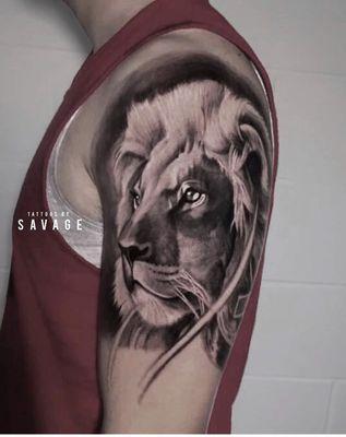 Lion shoulder tattoo. Large black and grey