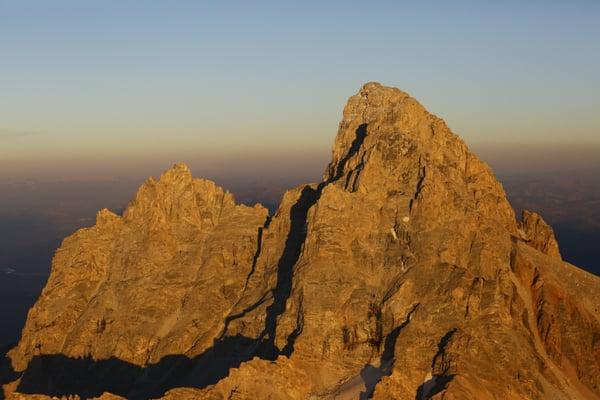 Sunset on the peak of the Grand Teton in Grand Teton National Park. See the top of the summit of Grand Teton mountain