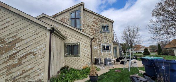 Before picture of a home with a lot of chipped paint.  We helped restore this beautiful house.