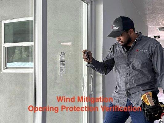 Home inspector inspecting the opening protection as part of a wind mitigation inspection.