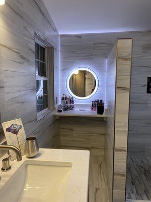 Back lit Vanity with a matching quartz shelf.