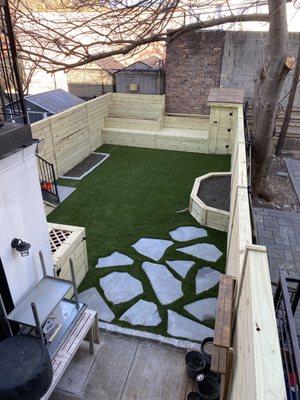 Fence, garden shed, seating area, planters, artificial grass, stepping stones