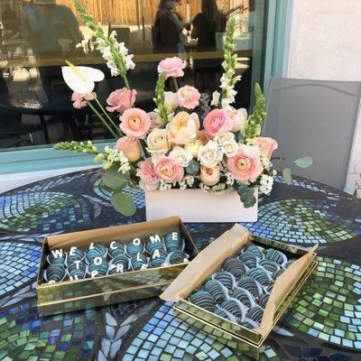 Flowers & chocolate covered strawberries at an event held in the courtyard