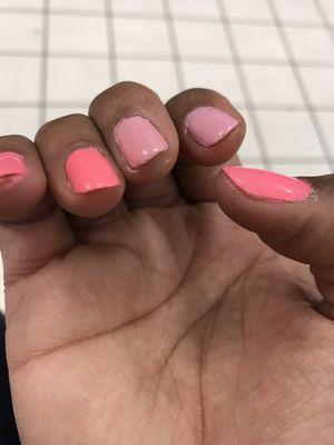 The light pink is the first time they did my nails. Please tell me how her painting my cuticles is my fault. Horrible job