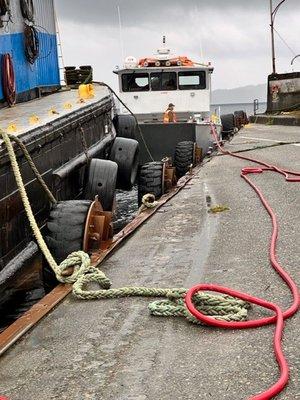 Transferring fuel from the Remote supplier to construction equipment on the neighboring island of Gravina